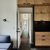Resource Furniture Flex Sofa, Bento Build Lattice Kitchen System, Rich Brilliant Willing Monocle sconce, Insteon dimmer, Smeg espresso maker, countertops made of Richlite, tile floor by Ann Sacks, engineered bamboo floor by Cali Bamboo and Plumen LED 003 lights in background.
